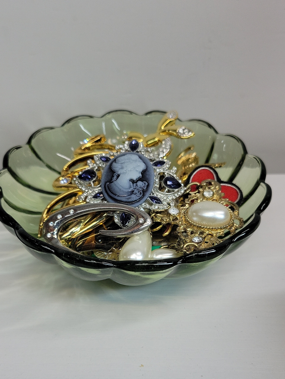 Green Glass Dish Filled With Brooches